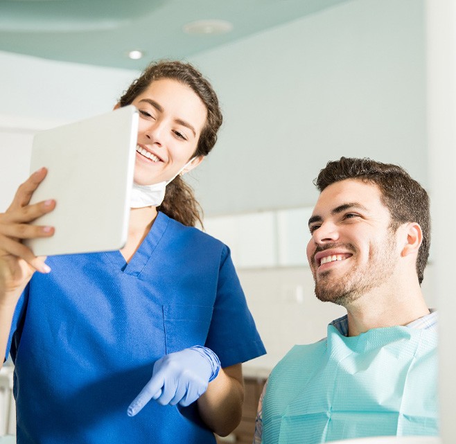 Dental hygienist discusses postop instructions with patient