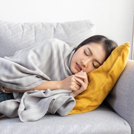 Lady sleeps on couch