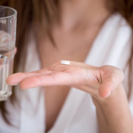 Lady prepares to take pill