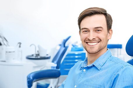 Happy dental patient, smiling after advanced dental implant procedures