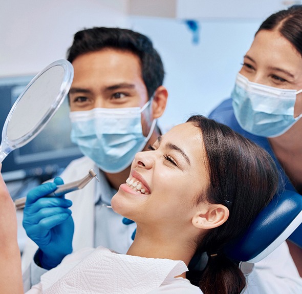 A woman smiling after dental treatment 