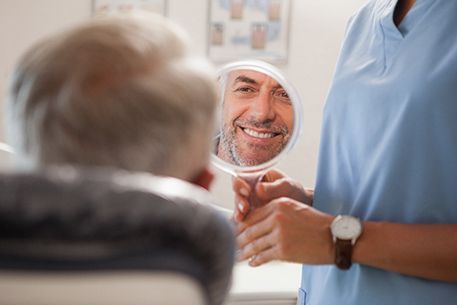 A smiling man happy with his dental bridges