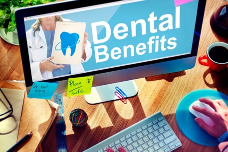 a computer with the words “dental benefits” on the screen