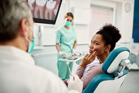Emergency dentist in Cottonwood Heights speaking with a dentist