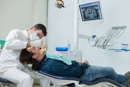 Dentist completing a comprehensive oral exam