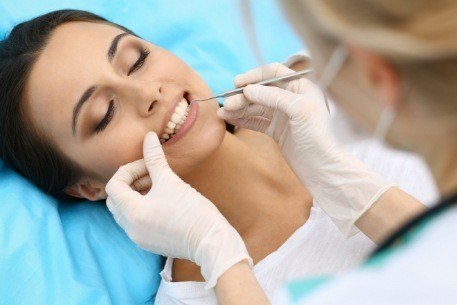 Dentist examining smile to provide a gum disease diagnosis