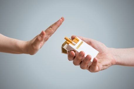 Person refusing a cigarette offered by someone else