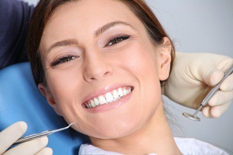 Woman visiting the dentist to develop an oral health maintenance plan