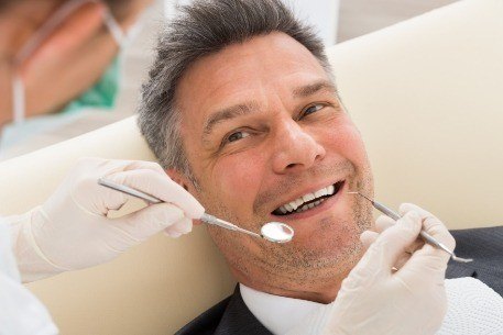 Man discussing preventive dentistry strategies with his dentist