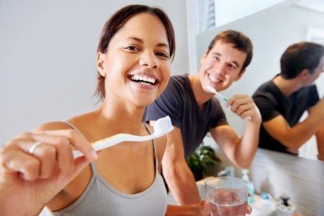 Man and woman keeping up with their at home oral hygiene routine