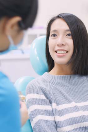 Woman talking to dentist during preventive dentistry visit