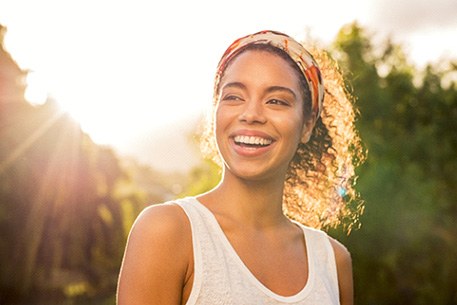 A young woman smiling during sunset