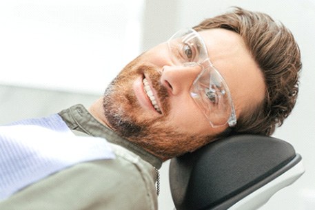 A smiling man who just received tooth-colored fillings