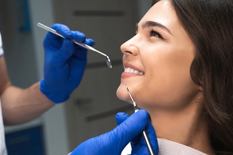 Woman with veneers in Cottonwood Heights smiling at dentist