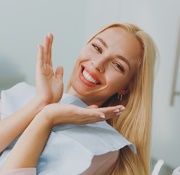 Woman smiling while sitting in treatment chair