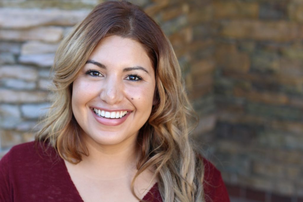 Woman with dental crown smiling outside