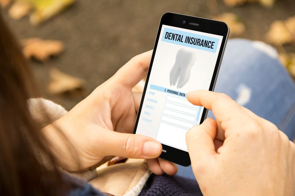 Patient looking up dental insurance information on phone